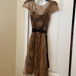 Copper, sparkly cap sleeved dress with black sash